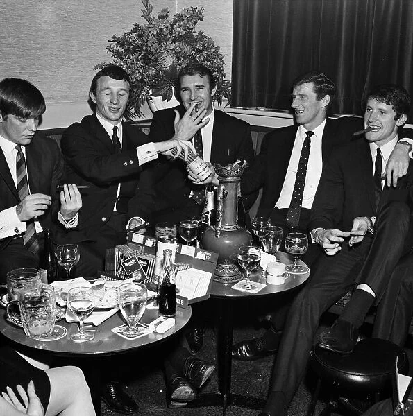 Manchester City players and management staff celebrate with a few drinks