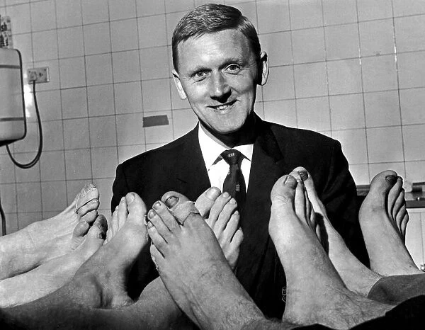 Manchester Citys physiotherapist Peter Blakey inspects the feet of Manchester City