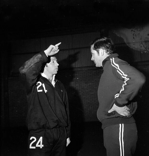Manchester United assistant manager Wilf Mcguiness talks with Nobby Stiles during a