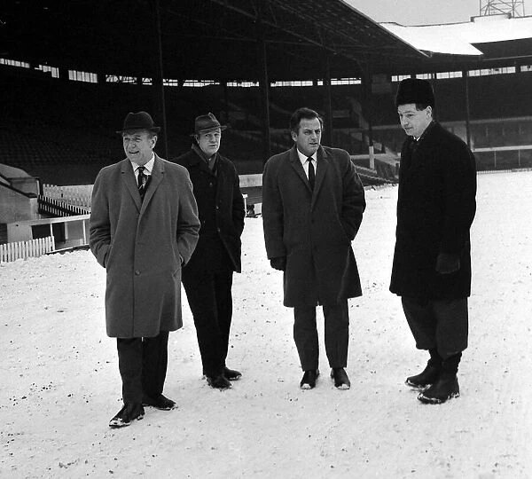 Manchester united assistant manager Wilf McGuinness inspects the pitch at Old Trafford