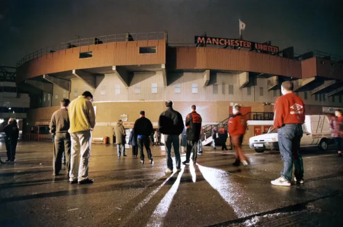 Framed Print : Manchester United fans bow their heads in respect during a slient vigil outside Old