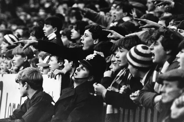 Framed Print : Manchester United fans fail to win the support of a policeman in 1966 Framed Print : Manchester United fans fail to win the support of a policeman in 1966