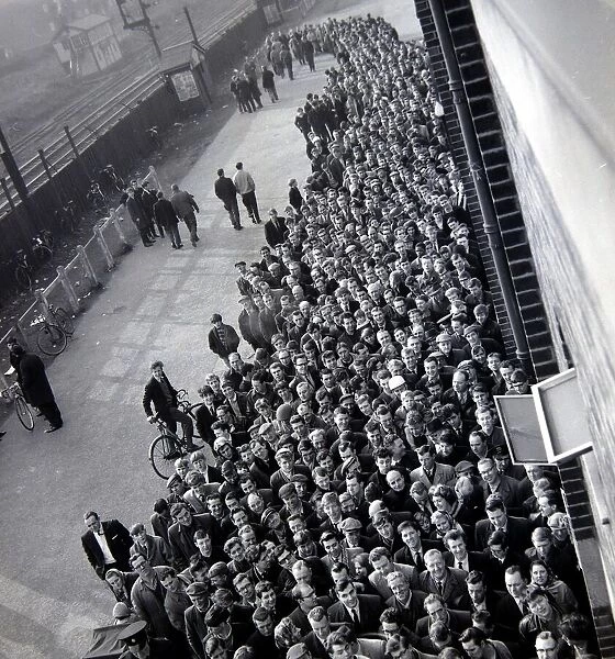 Manchester United fans queue for tickets at Old Trafford for the FA Cup semi final match