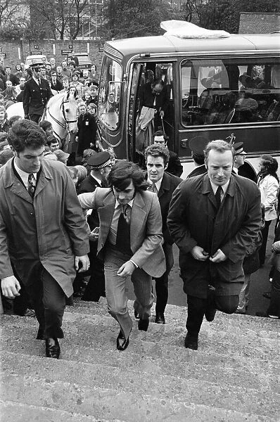 Manchester United football star George Best, surrounded by body guards after receiving
