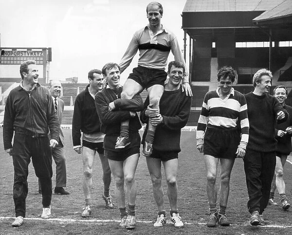 Manchester United footballer Bobby Charlton is carried around Old Trafford football
