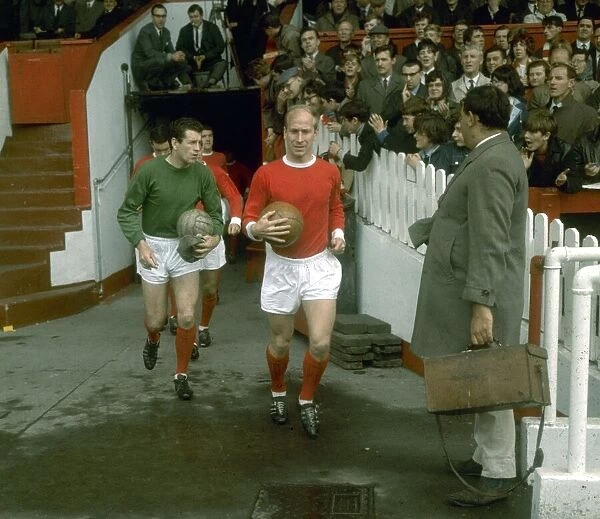 Manchester United footballer Bobby Charlton leads his team out onto the pitch at old