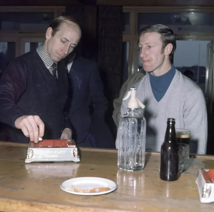 Framed Print : Manchester United footballer Bobby Charlton puts out a cigarette in the ash try as he Framed Print : Manchester United footballer Bobby Charlton puts out a cigarette in the ash try as he