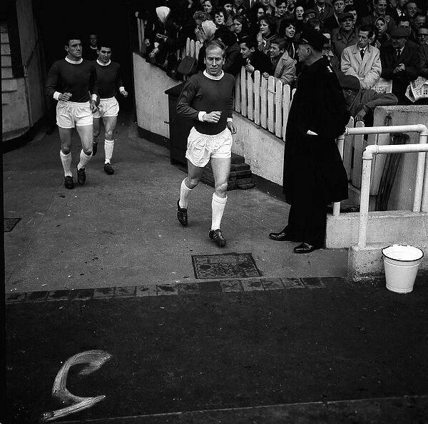 Manchester United footballer Bobby Charlton runs out on to the pitch for the league match