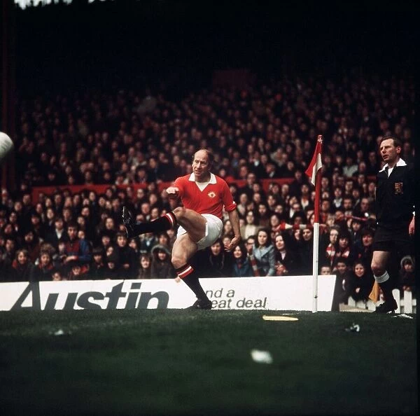 Manchester United footballer Bobby Charlton takes a corner during his last game at Old