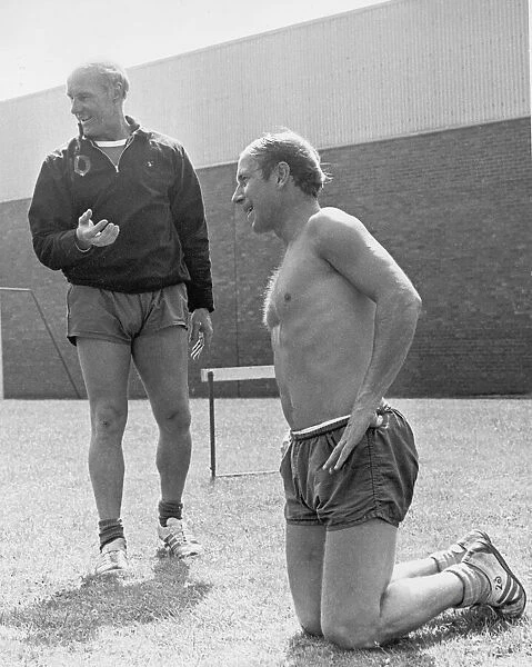 Manchester United footballer Bobby Charlton takes a breather as he sits on his knees
