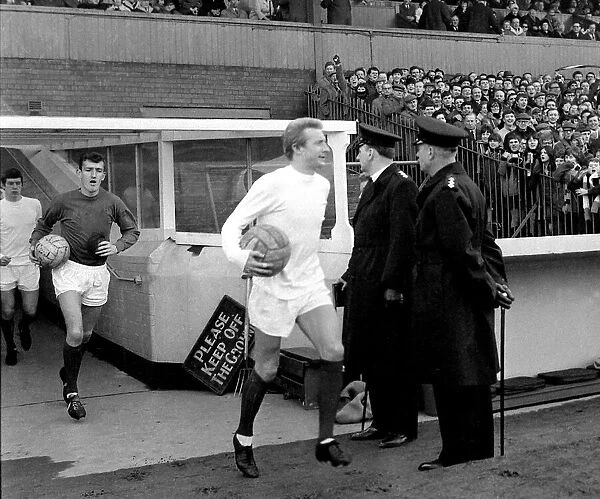 Manchester United footballer Denis Law walks out onto the pitch before their match with