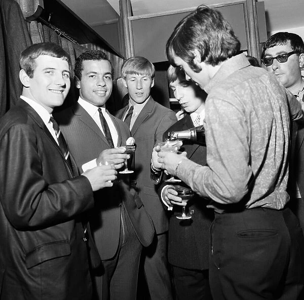 Manchester United footballer George Best celebrates the opening of his fashion boutique
