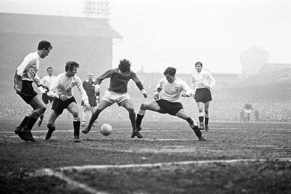 Manchester United footballer George Best in action to beat three defenders during the FA