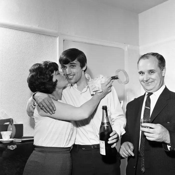 Framed Print : Manchester United footballer George Best with black eye holding champagne bottle as he Framed Print : Manchester United footballer George Best with black eye holding champagne bottle as he