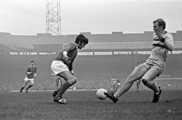 Manchester United footballer George Best faced by Bobby Moore of West Ham during