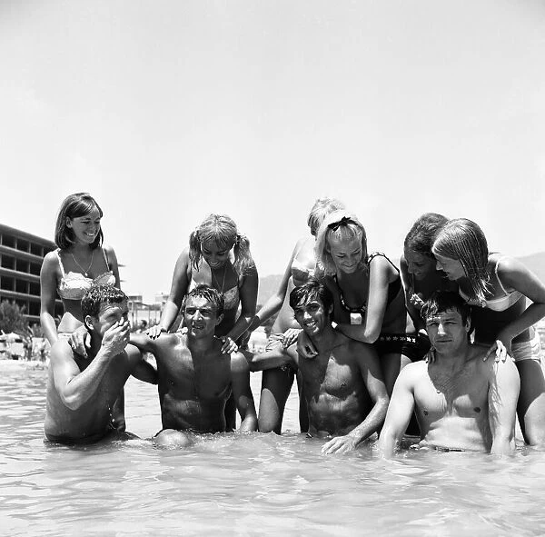 Manchester United footballer George Best with friends including Mike Summerbee cool off