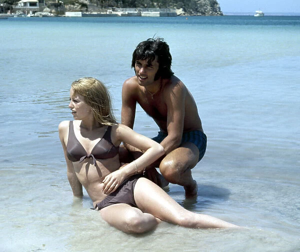 Manchester United footballer George Best on holiday with girlfriend Susan George while