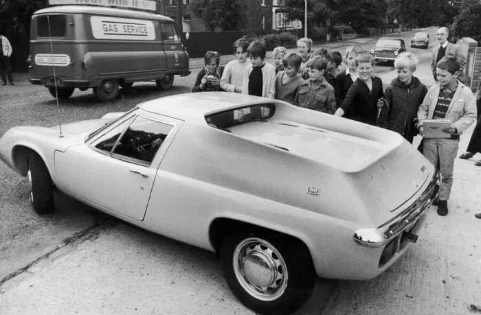 Framed Print : Manchester United footballer George Best surrounded by young fans as he drives away in