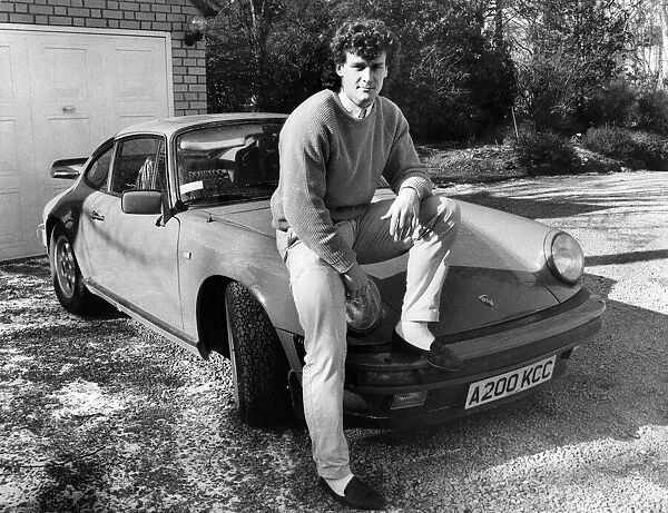 Manchester United footballer Mark Hughes 22, poses with his German built Porsche sports