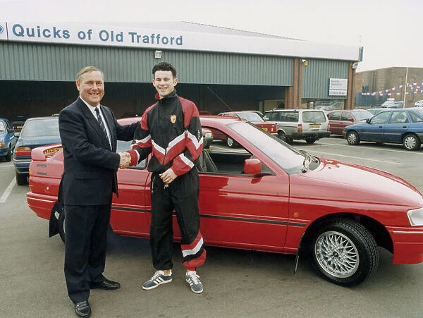 Manchester United footballer Ryan Giggs accepts the keys to his new car from Jim Quick