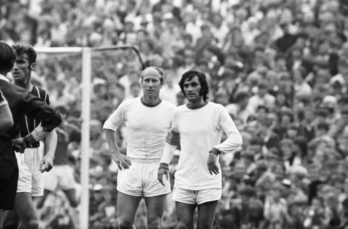 Framed Print : Manchester United footballers Bobby Charlton and George Best await a free kick during Framed Print : Manchester United footballers Bobby Charlton and George Best await a free kick during