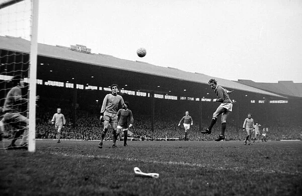 Manchester United forward Denis Law heads the ball towards goal during the league match