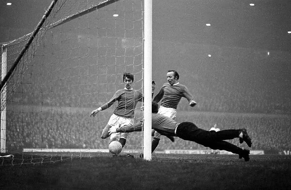 Manchester United goalkeeper Alex Stepney dives to pounce on the ball