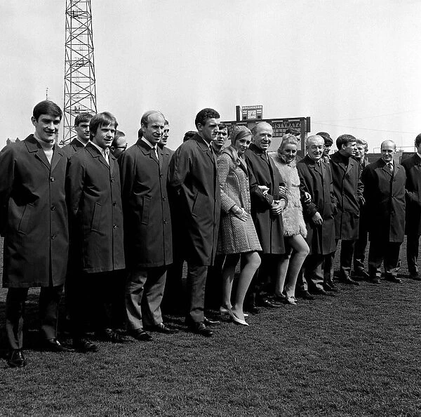 Manchester United manager Matt Busby poses with members of his team all wearing long