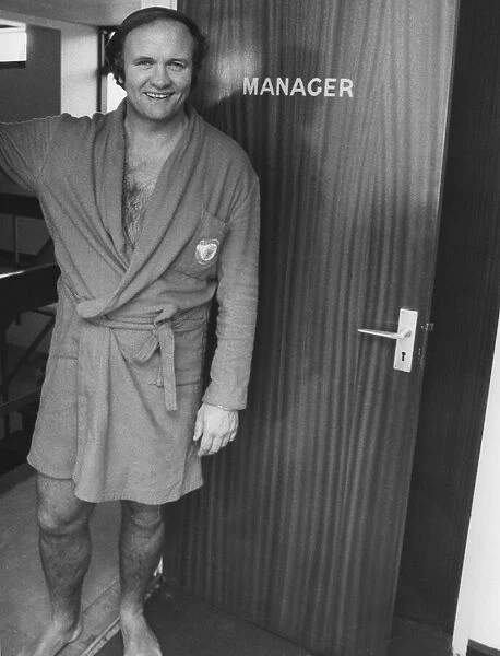 Manchester United manager Ron Atkinson stands at the doorway to the manager