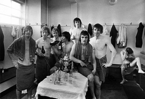 Manchester United players celebrate in the changing rooms after being promoted back into