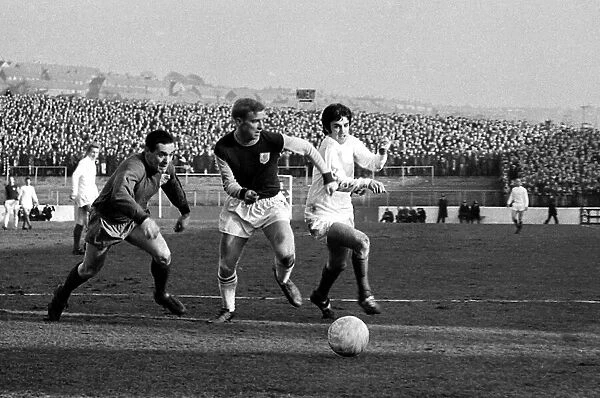 Manchester United star George Best dashes for the ball with Burnley goalkeeper Thomson