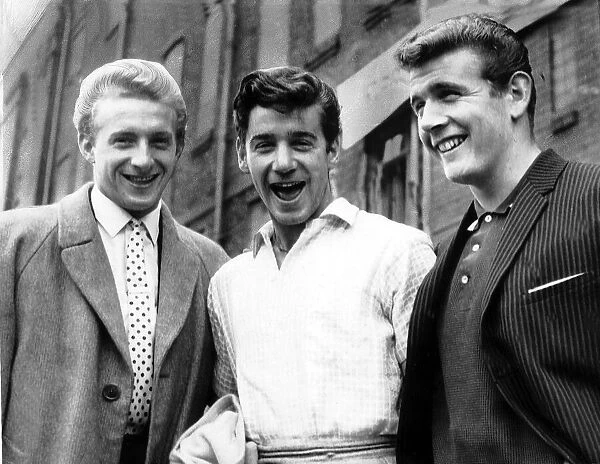 manchester United striker Denis Law with footballing brothers Gerry Baker
