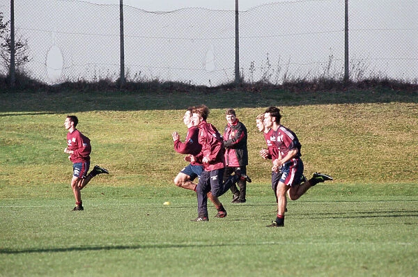 Manchester United in training. David Beckham running with Gary and Phil Neville