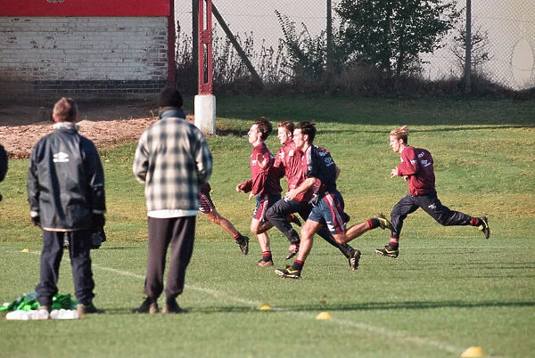 Manchester United in training. David Beckham running with Gary and Phil Neville