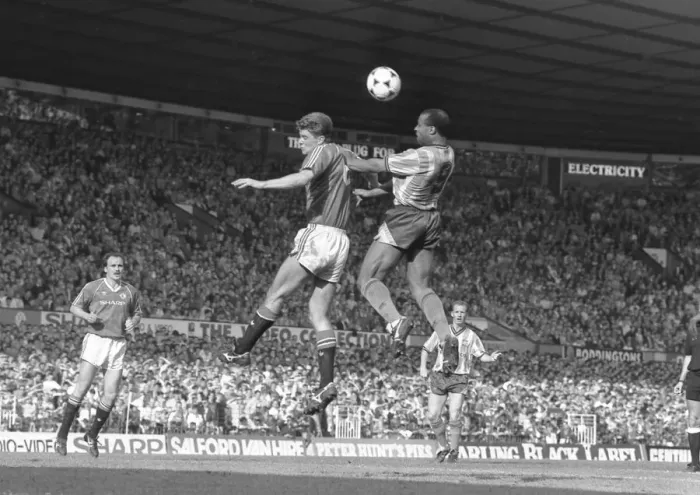 Framed Print : Manchester United v Coventry City. Cyrille Regis wins the header against Manchester Framed Print : Manchester United v Coventry City. Cyrille Regis wins the header against Manchester