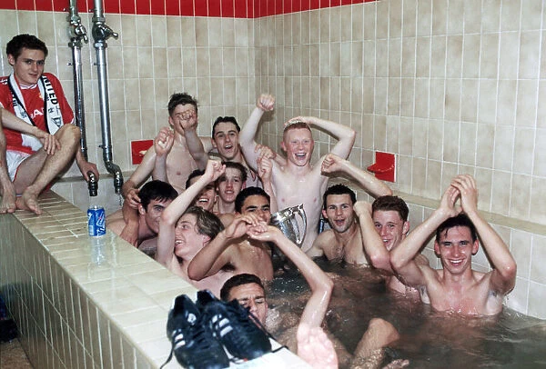 Manchester United youth team celebrate in the bath with the FA Youth Cup trophy after