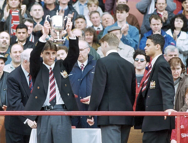 Manchester United youth team footballer Gary Neville holds aloft the Lancashire League