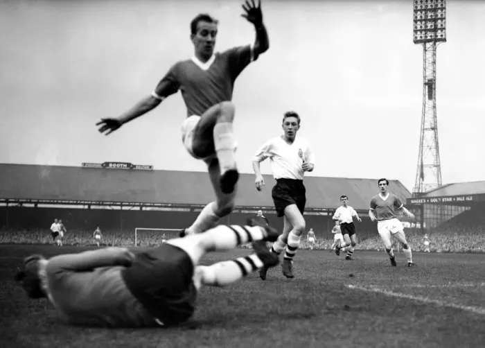 Framed Print : Manchester Uniteds Bobby Charlton jumps to clear the diving body of Bolton