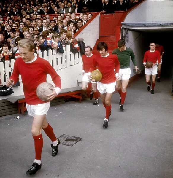Manchester Uniteds Denis Law leads out teammates Nobby Stiles, George Best