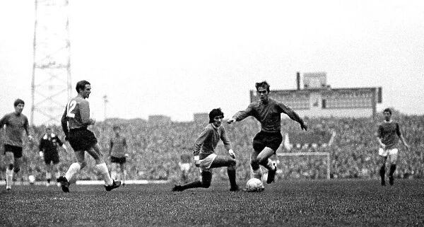 Manchester Uniteds George Best challenges an Ipswich player for the ball during