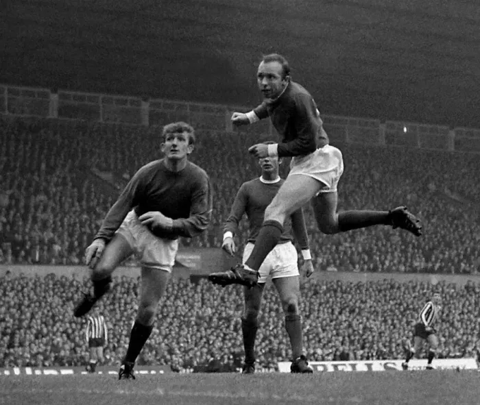 Framed Print : Manchester Uniteds goalkeeper Alex Stepney looks on anxiously as defender Nobby Framed Print : Manchester Uniteds goalkeeper Alex Stepney looks on anxiously as defender Nobby