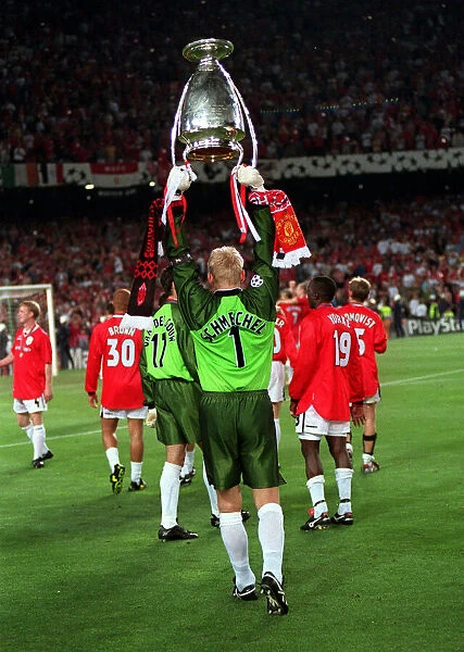 Manchester Uniteds Peter Schmeichel holds the European Cup as he salutes the crowd
