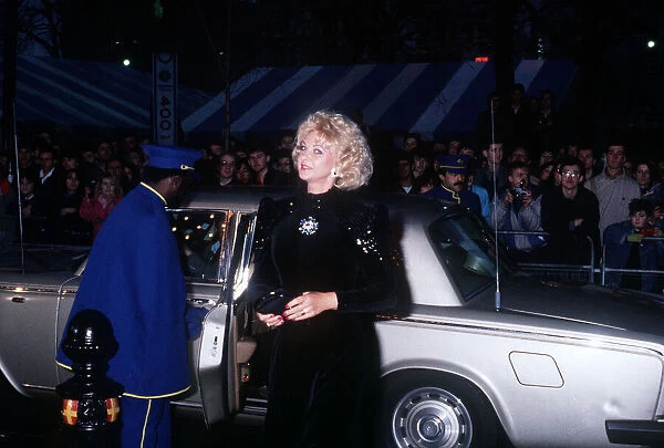 Mandy Rice Davies premiere film Absolute Beginners black dress car door opened by caped