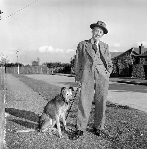 Mans best friend: Man walking a dog. Circa 1954