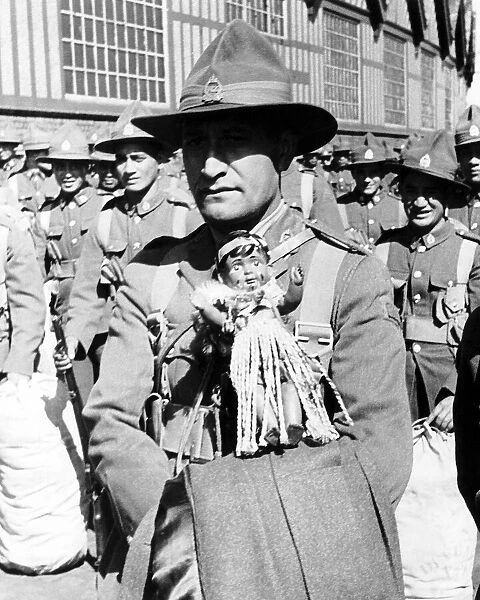 Maori soldier carries his Maori doll as a mascot as he arrives in Britain to take part in