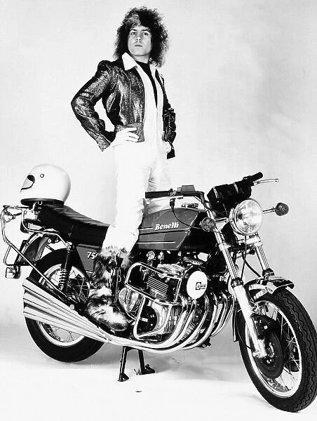 Marc Bolan singer standing on motorcycle - 1976