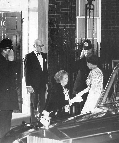 Margaret Thatcher curtsying to the Queen outside 10 Downing Street watched by Denis