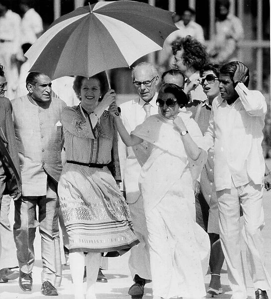 Margaret Thatcher and Indira Ghandi walking in India beneath umbrella - 19th April 1981