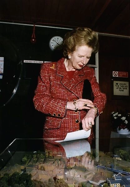 Margaret Thatcher looking at a model of the promised £