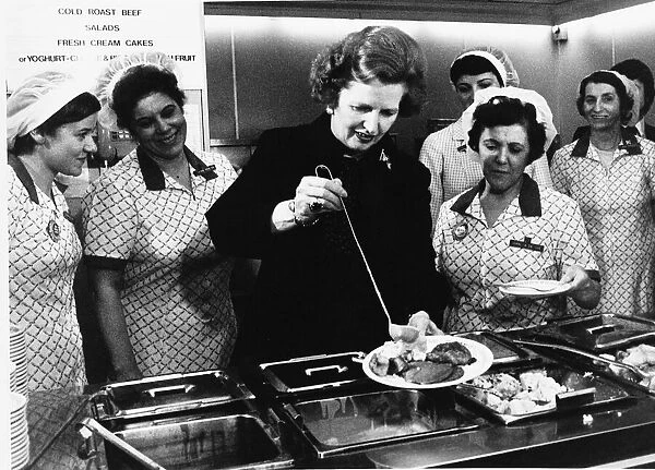 Margaret Thatcher Prime Minister takes her turn serving behind a staff canteen counter
